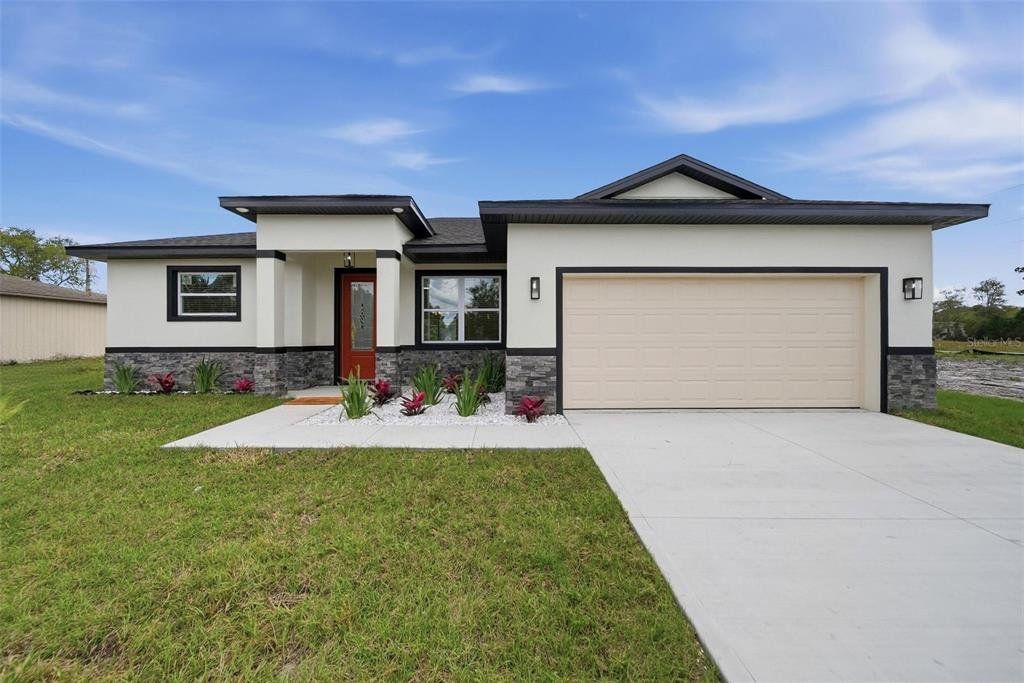 Front exterior of a new home in , Palm Bay, FL, highlighting curb appeal (Image 1). Front exterior of a new home in , Palm Bay, FL, highlighting curb appeal (Image 1).