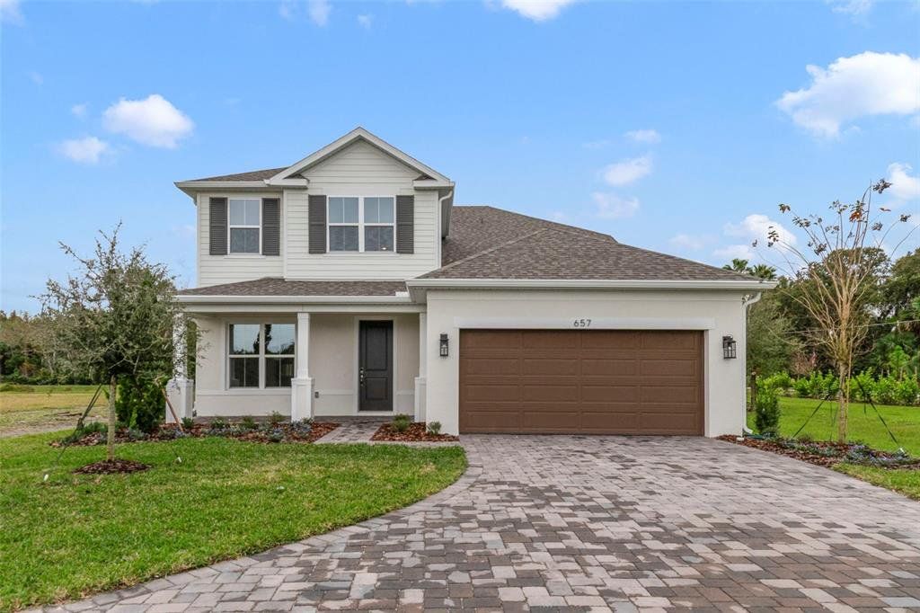 Front exterior of a new home in Estates at Lake Jesup, Sanford, FL, highlighting curb appeal (Image 1). Front exterior of a new home in Estates at Lake Jesup, Sanford, FL, highlighting curb appeal (Image 1).