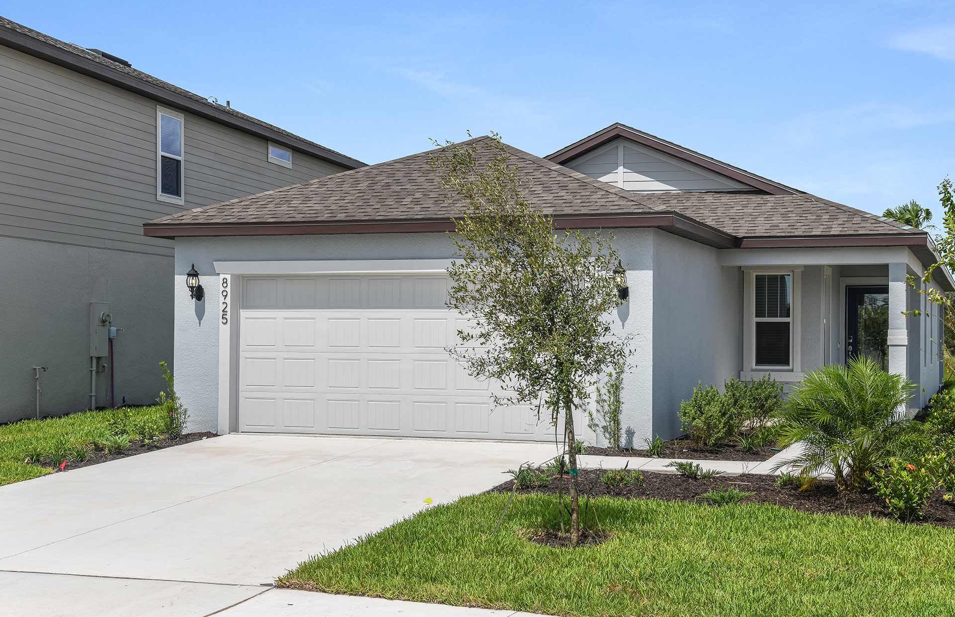 Front exterior of a new home in Oakfield Lakes, Parrish, FL, highlighting curb appeal (Image 1). Front exterior of a new home in Oakfield Lakes, Parrish, FL, highlighting curb appeal (Image 1).