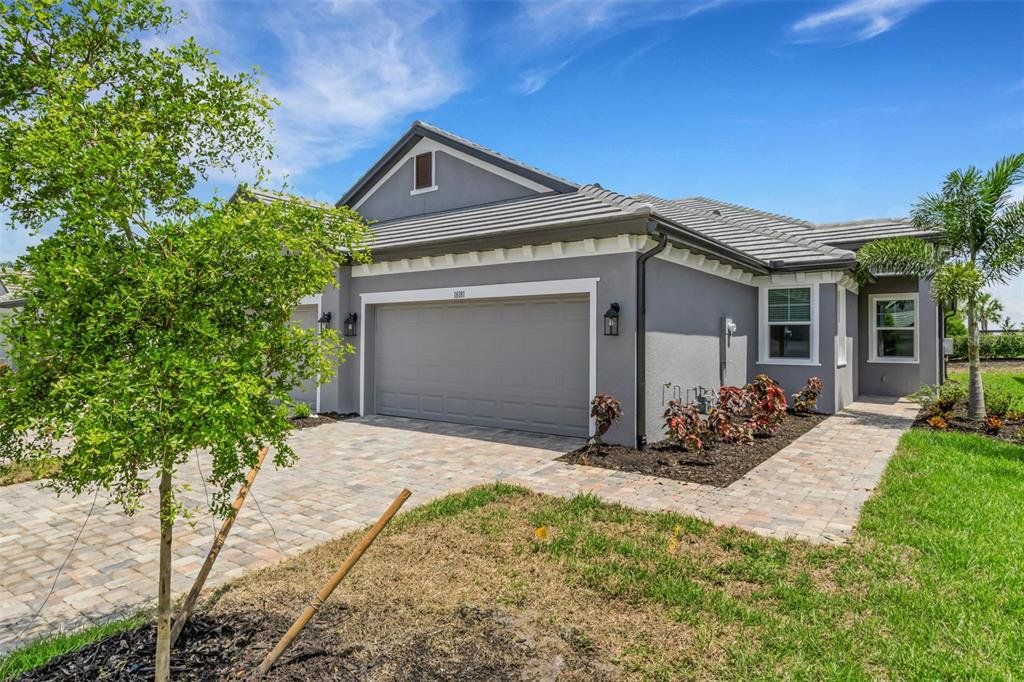 Front exterior of a new home in Sweetwater at Lakewood Ranch, Lakewood Ranch, FL, highlighting curb appeal (Image 1). Front exterior of a new home in Sweetwater at Lakewood Ranch, Lakewood Ranch, FL, highlighting curb appeal (Image 1).