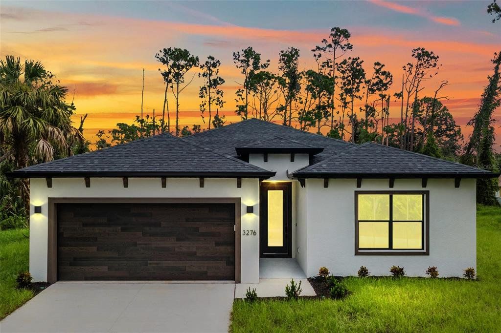Front exterior of a new home in , North Port, FL, highlighting curb appeal (Image 1). Front exterior of a new home in , North Port, FL, highlighting curb appeal (Image 1).