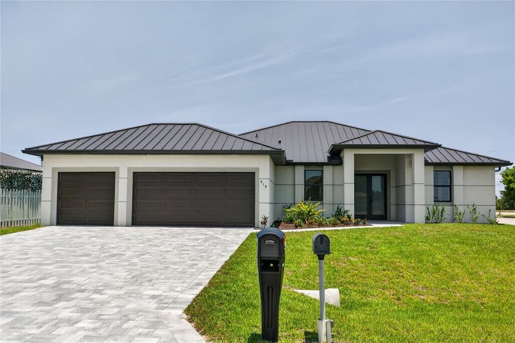 Front exterior of a new home in , Cape Coral, FL, highlighting curb appeal (Image 1). Front exterior of a new home in , Cape Coral, FL, highlighting curb appeal (Image 1).