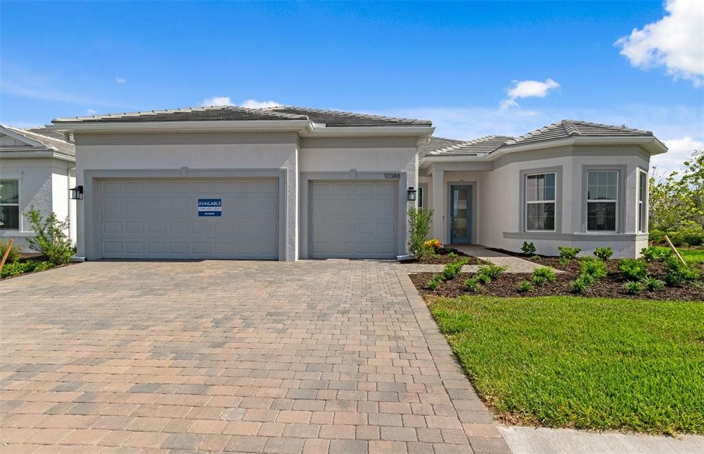 Front exterior of a new home in BeachWalk by Manasota Key, Englewood, FL, highlighting curb appeal (Image 1). Front exterior of a new home in BeachWalk by Manasota Key, Englewood, FL, highlighting curb appeal (Image 1).