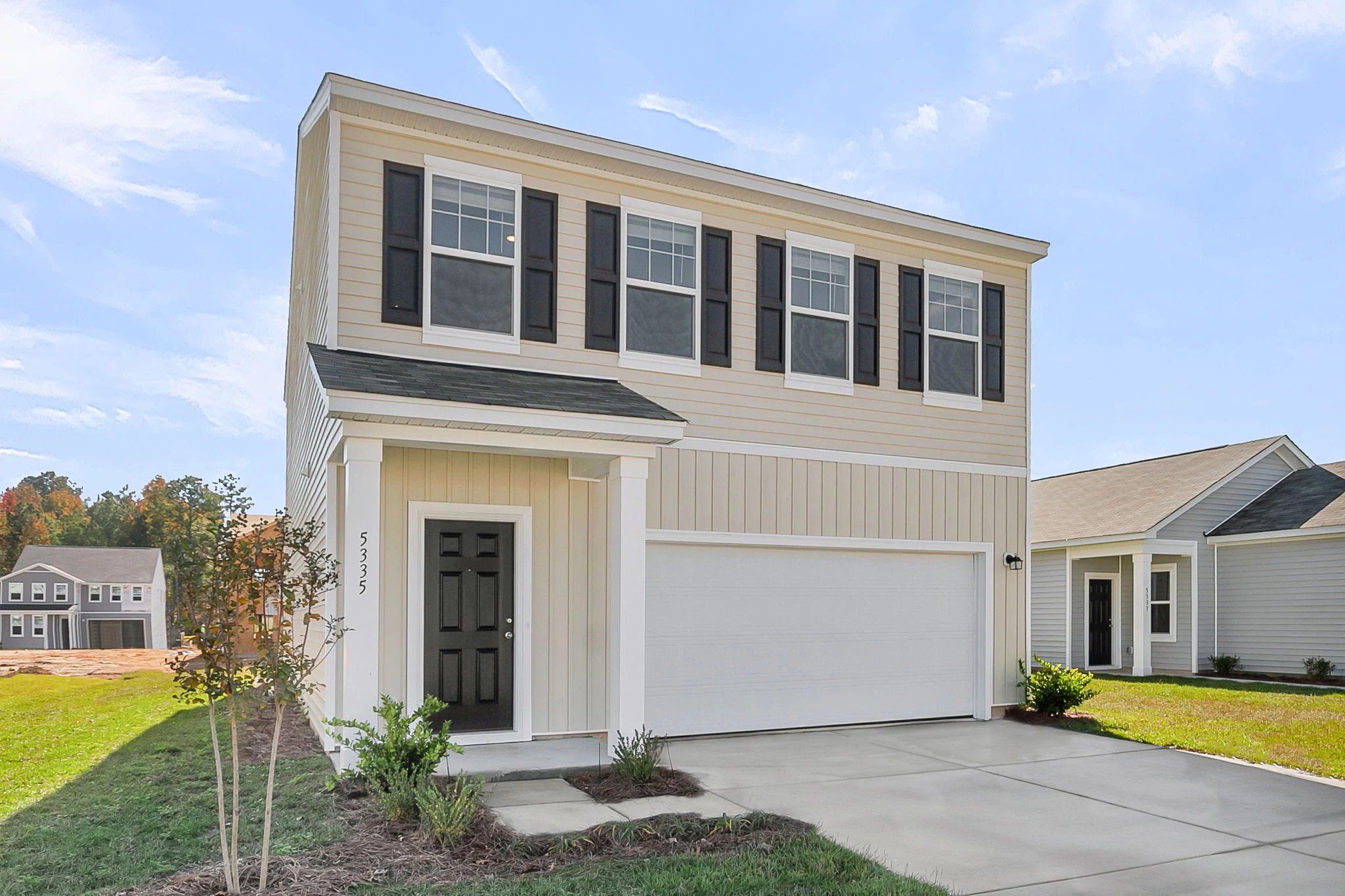 Front exterior of a new home in Pender Woods at Cane Bay, Summerville, SC, highlighting curb appeal (Image 1). Front exterior of a new home in Pender Woods at Cane Bay, Summerville, SC, highlighting curb appeal (Image 1).