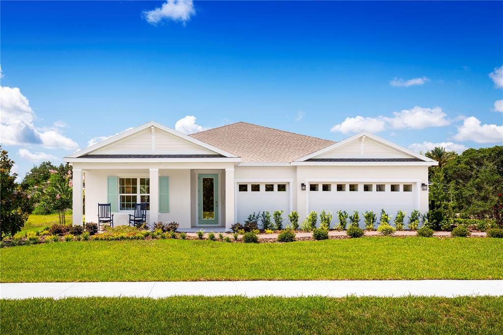 Front exterior of a new home in Ashton Covey, Winter Haven, FL, highlighting curb appeal (Image 1). Front exterior of a new home in Ashton Covey, Winter Haven, FL, highlighting curb appeal (Image 1).