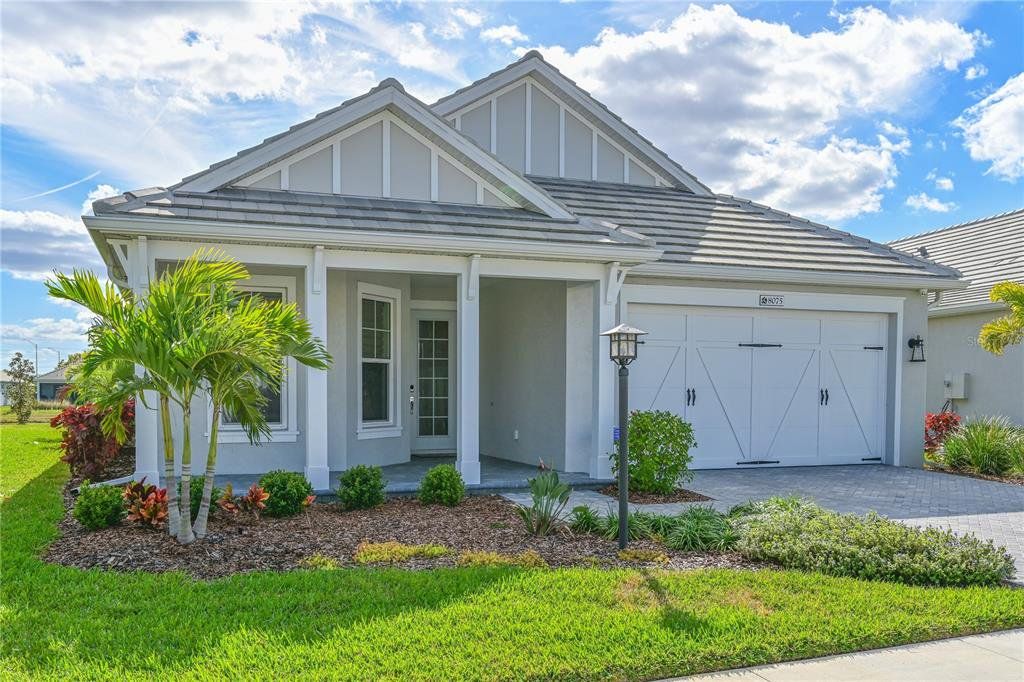 Front exterior of a new home in LakeHouse Cove at Waterside, Sarasota, FL, highlighting curb appeal (Image 1). Front exterior of a new home in LakeHouse Cove at Waterside, Sarasota, FL, highlighting curb appeal (Image 1).
