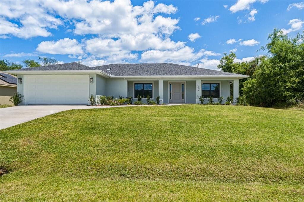 Front exterior of a new home in , Englewood, FL, highlighting curb appeal (Image 1). Front exterior of a new home in , Englewood, FL, highlighting curb appeal (Image 1).