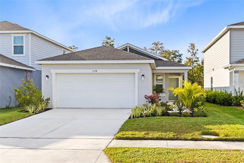 Front exterior of a new home in Cypress Hammock, Kissimmee, FL, highlighting curb appeal (Image 1). Front exterior of a new home in Cypress Hammock, Kissimmee, FL, highlighting curb appeal (Image 1).