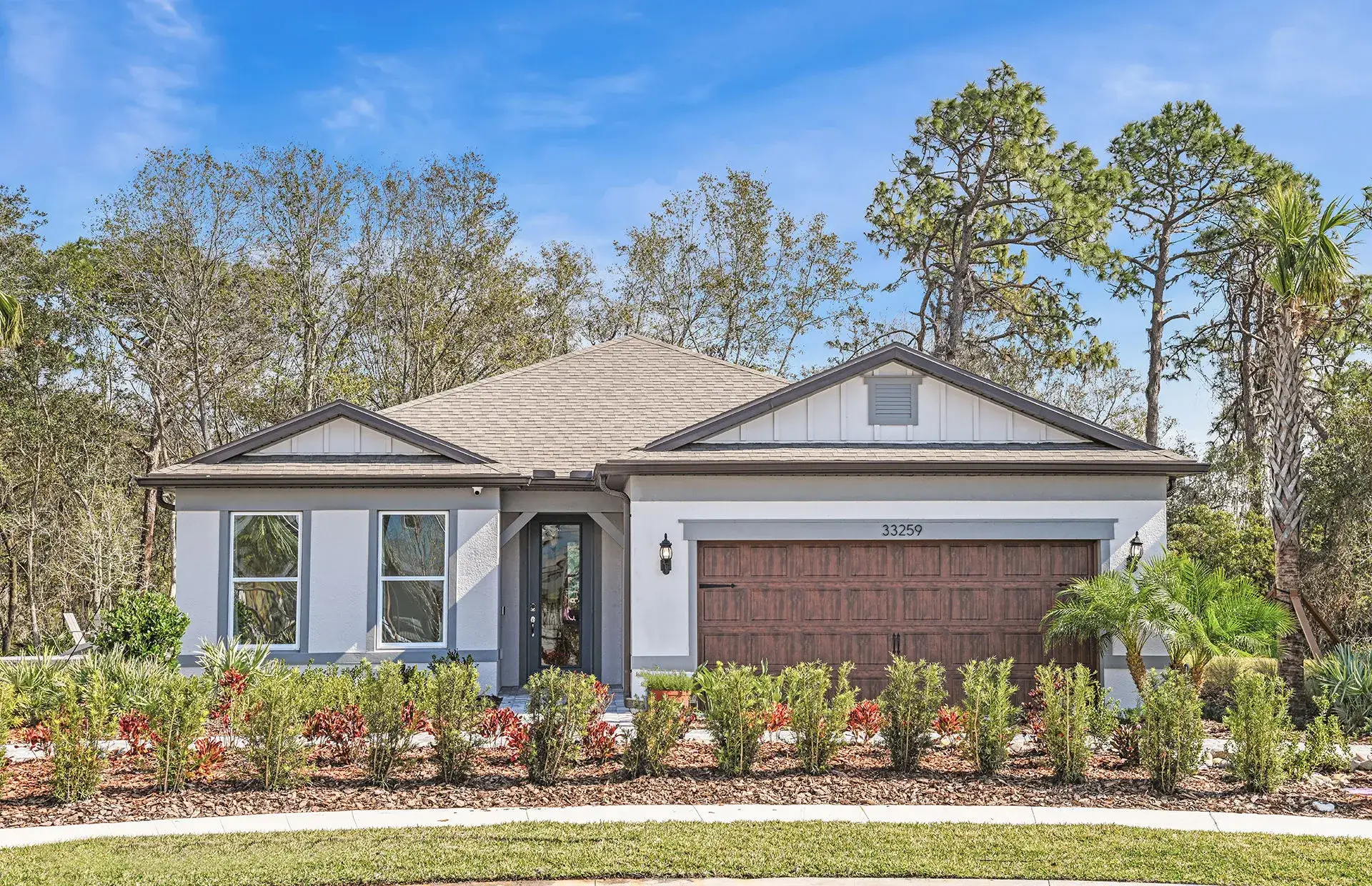 Front exterior of a new home in Vida's Way, Wesley Chapel, FL, highlighting curb appeal (Image 1). Front exterior of a new home in Vida's Way, Wesley Chapel, FL, highlighting curb appeal (Image 1).