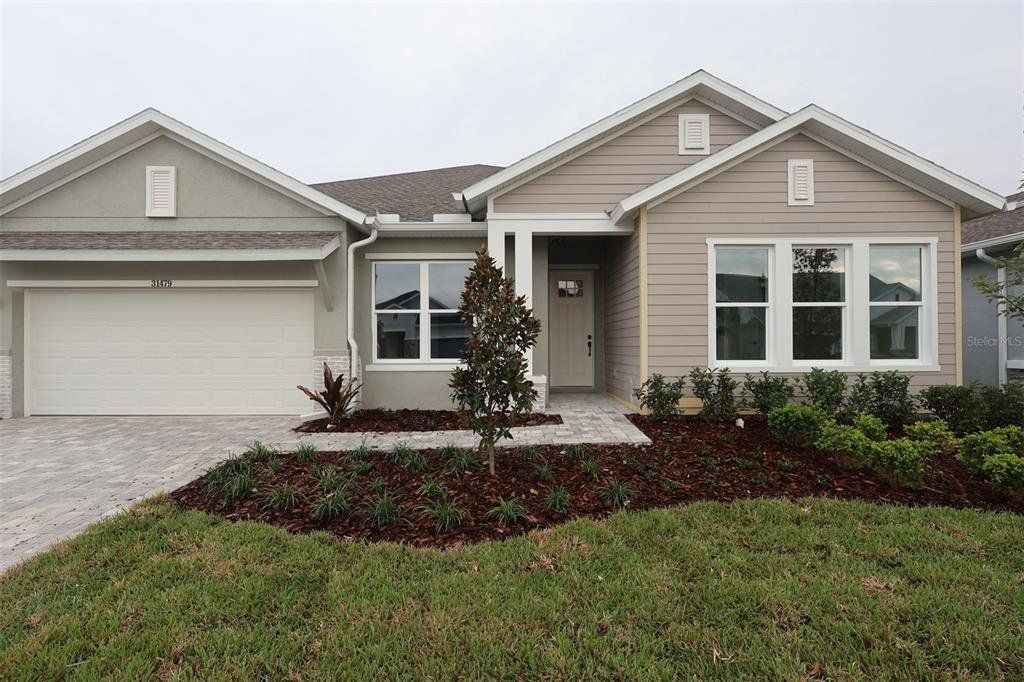Front exterior of a new home in Chapel Crossings, Wesley Chapel, FL, highlighting curb appeal (Image 1). Front exterior of a new home in Chapel Crossings, Wesley Chapel, FL, highlighting curb appeal (Image 1).