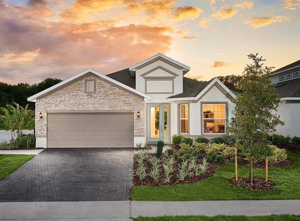 Front exterior of a new home in Leela Reserve, Tavares, FL, highlighting curb appeal (Image 1). Front exterior of a new home in Leela Reserve, Tavares, FL, highlighting curb appeal (Image 1).