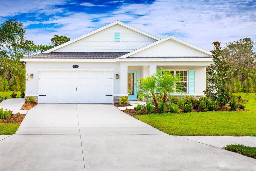 Front exterior of a new home in Hillwood Preserve, Bradenton, FL, highlighting curb appeal (Image 1). Front exterior of a new home in Hillwood Preserve, Bradenton, FL, highlighting curb appeal (Image 1).