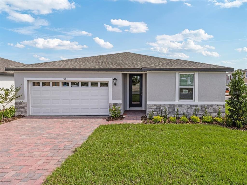 Front exterior of a new home in Eden Hills, Lake Alfred, FL, highlighting curb appeal (Image 1). Front exterior of a new home in Eden Hills, Lake Alfred, FL, highlighting curb appeal (Image 1).