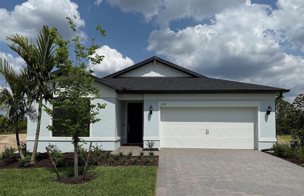 Front exterior of a new home in The Strand at Cedar Grove, North Port, FL, highlighting curb appeal (Image 1). Front exterior of a new home in The Strand at Cedar Grove, North Port, FL, highlighting curb appeal (Image 1).