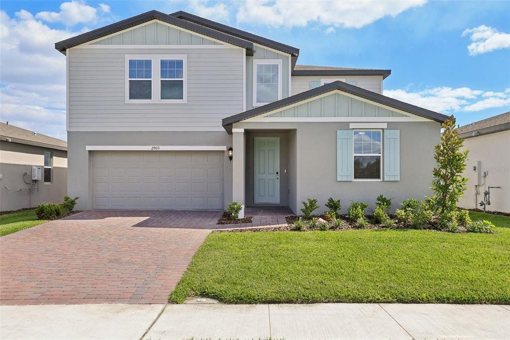 Front exterior of a new home in The Reserve at Twin Lakes, St. Cloud, FL, highlighting curb appeal (Image 1). Front exterior of a new home in The Reserve at Twin Lakes, St. Cloud, FL, highlighting curb appeal (Image 1).