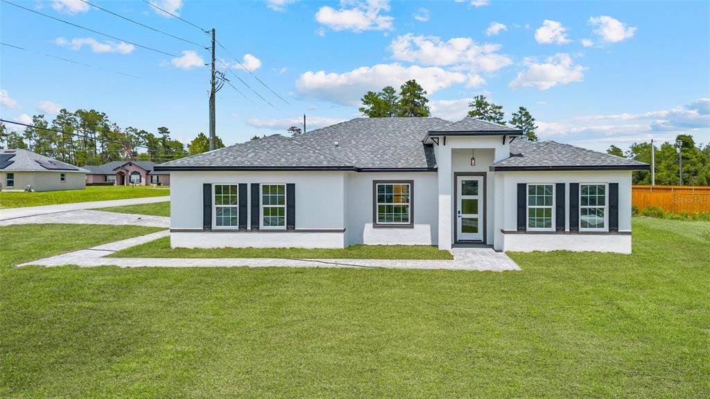 Front exterior of a new home in , Ocala, FL, highlighting curb appeal (Image 1).