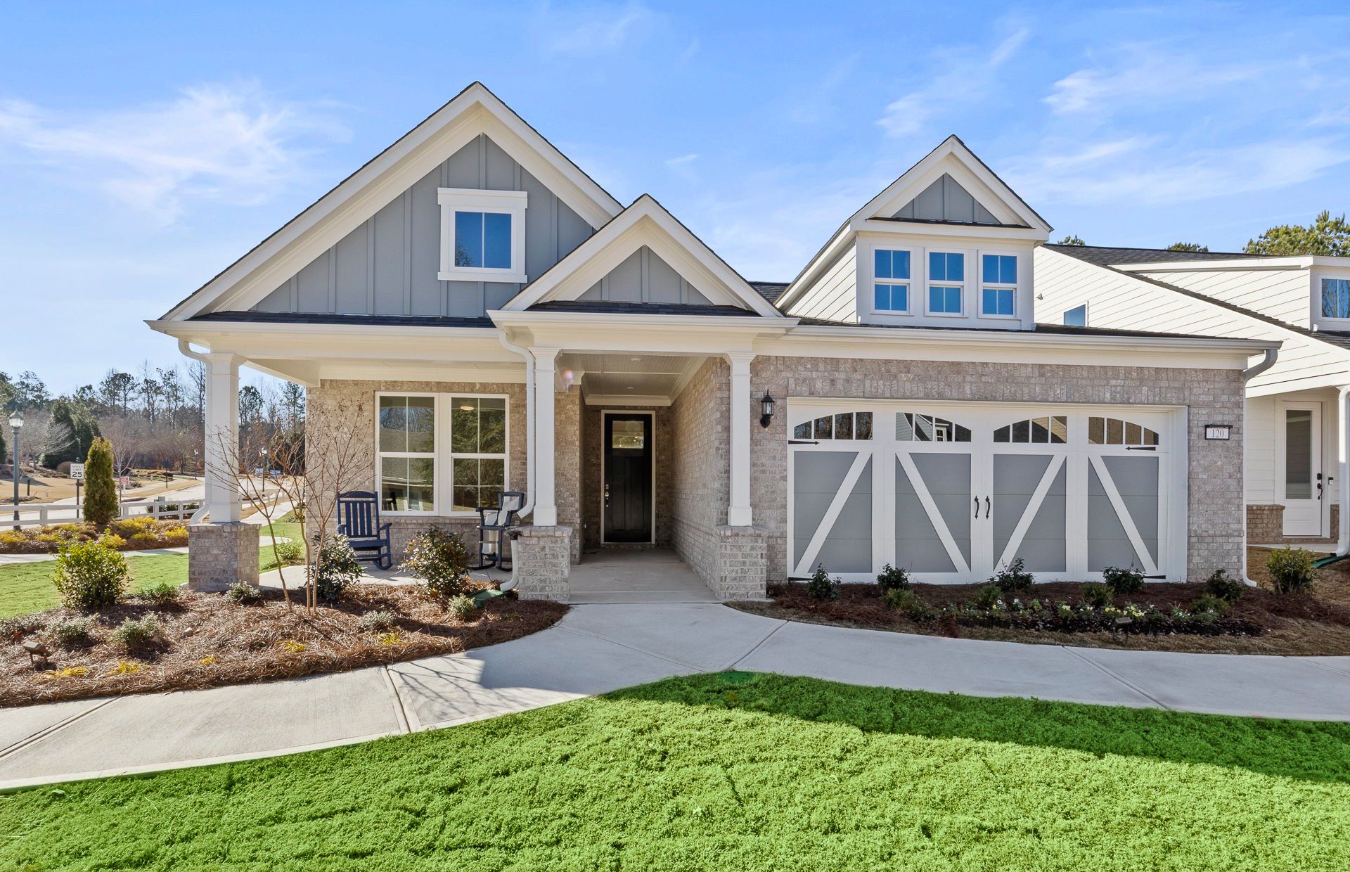 Front exterior of a new home in Sun City Peachtree, Griffin, GA, highlighting curb appeal (Image 1).