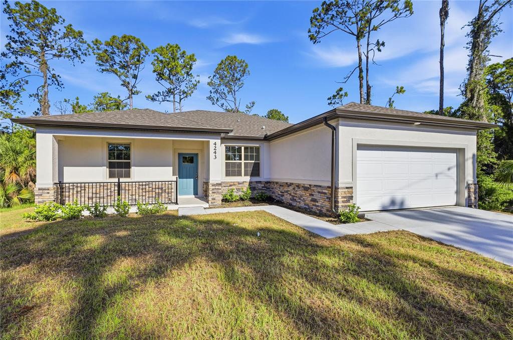 Front exterior of a new home in , North Port, FL, highlighting curb appeal (Image 1). Front exterior of a new home in , North Port, FL, highlighting curb appeal (Image 1).