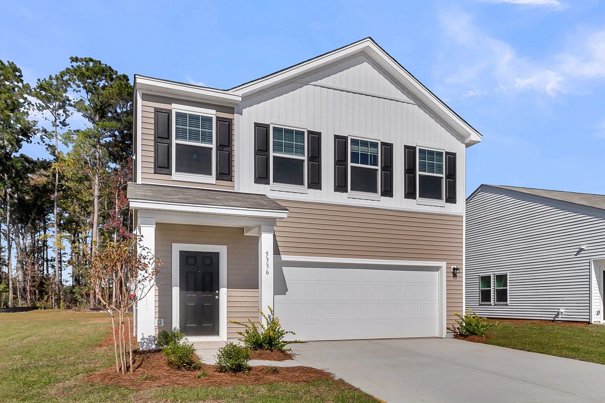 Front exterior of a new home in Pender Woods at Cane Bay, Summerville, SC, highlighting curb appeal (Image 1).
