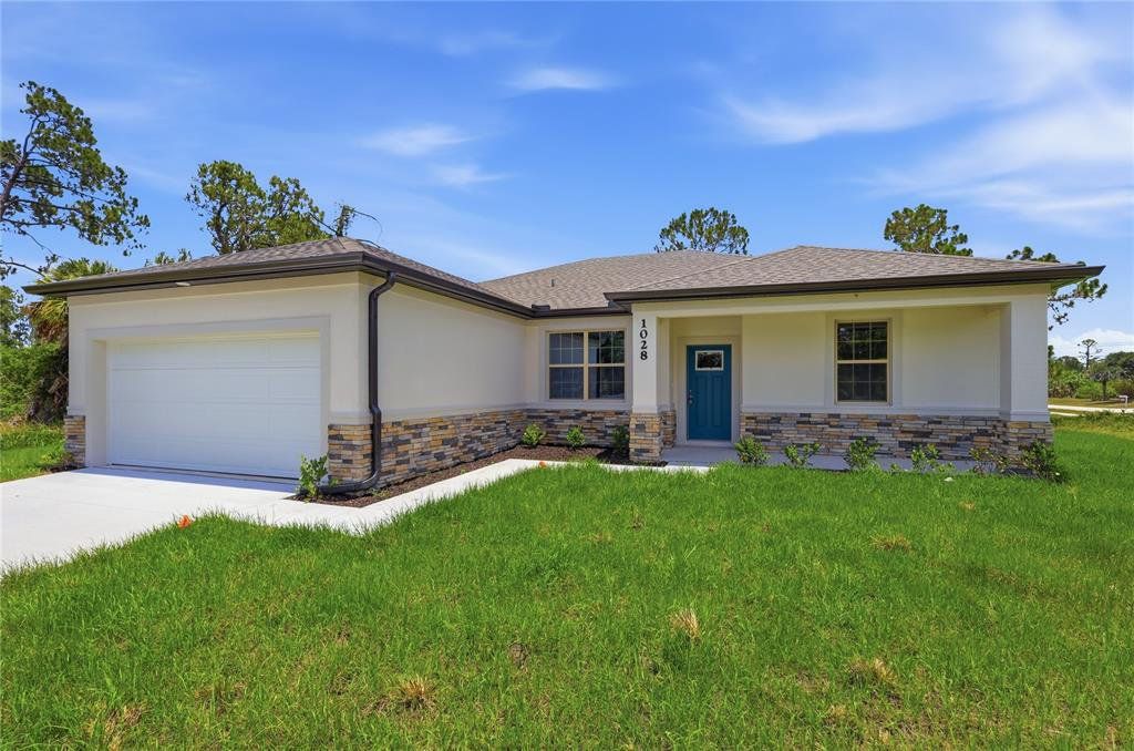 Front exterior of a new home in , North Port, FL, highlighting curb appeal (Image 1). Front exterior of a new home in , North Port, FL, highlighting curb appeal (Image 1).