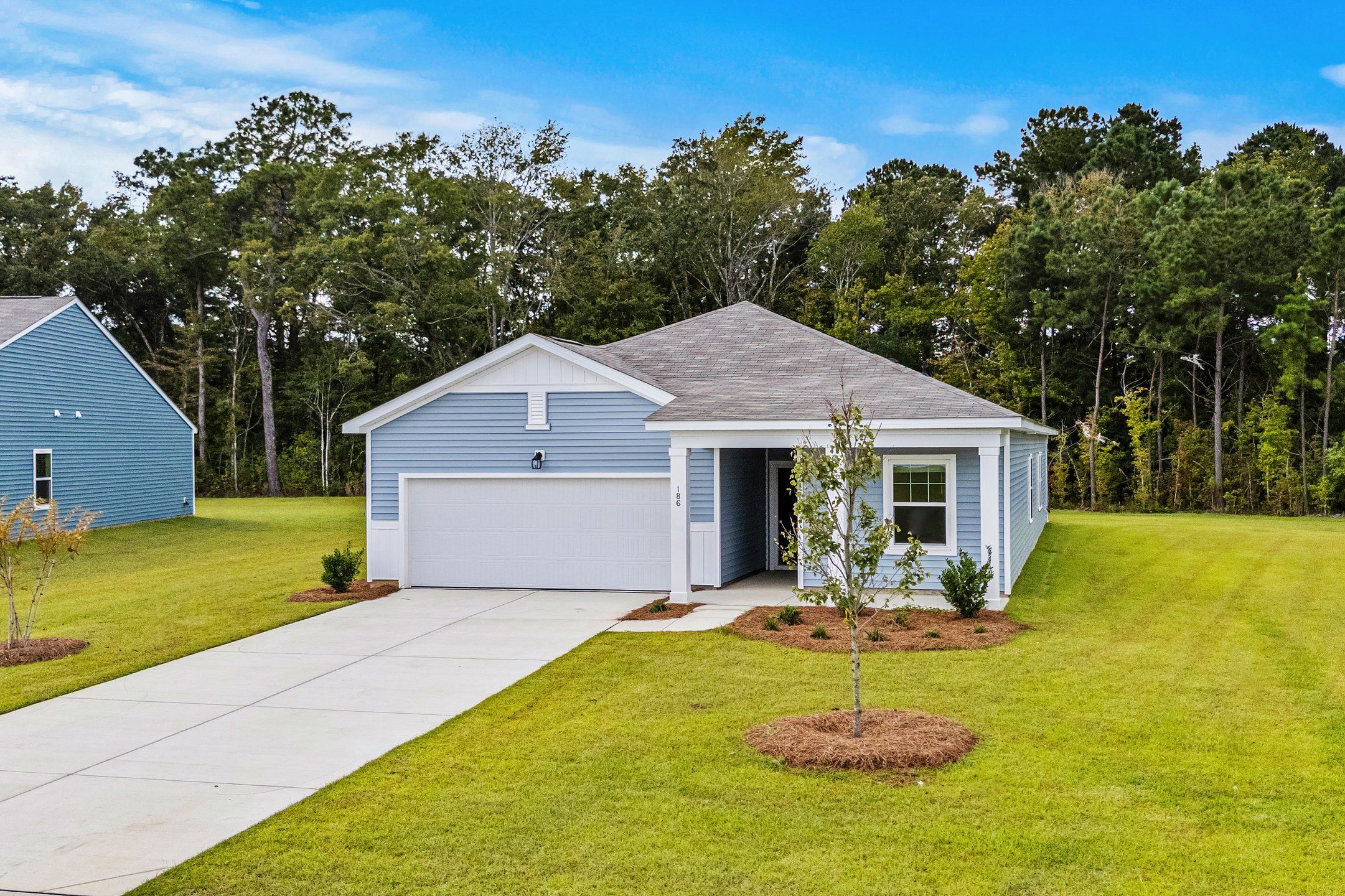 Front exterior of a new home in Bayview, Conway, SC, highlighting curb appeal (Image 1).