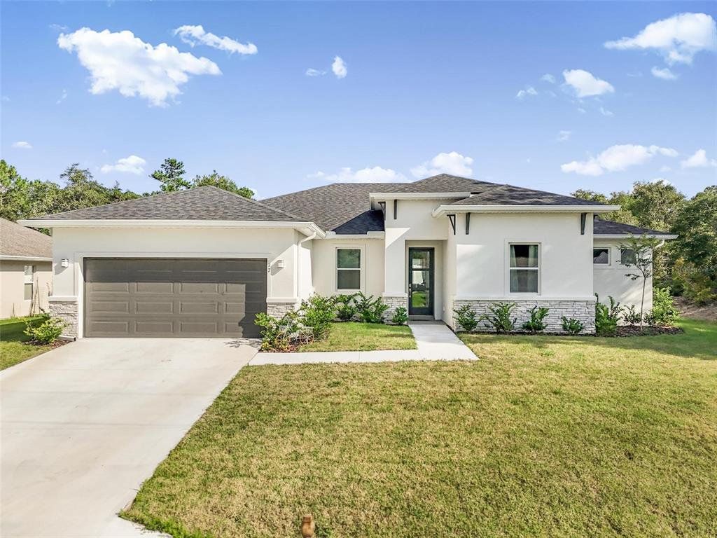 Front exterior of a new home in , Palm Coast, FL, highlighting curb appeal (Image 1). Front exterior of a new home in , Palm Coast, FL, highlighting curb appeal (Image 1).