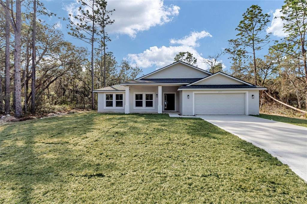 Front exterior of a new home in , Dunnellon, FL, highlighting curb appeal (Image 1). Front exterior of a new home in , Dunnellon, FL, highlighting curb appeal (Image 1).