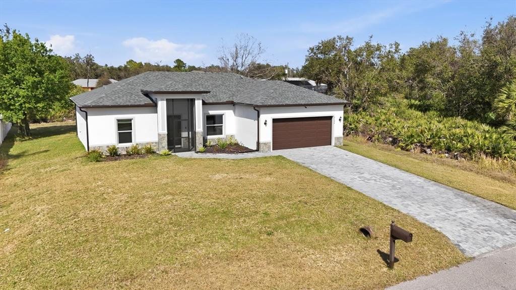 Front exterior of a new home in , North Port, FL, highlighting curb appeal (Image 1). Front exterior of a new home in , North Port, FL, highlighting curb appeal (Image 1).