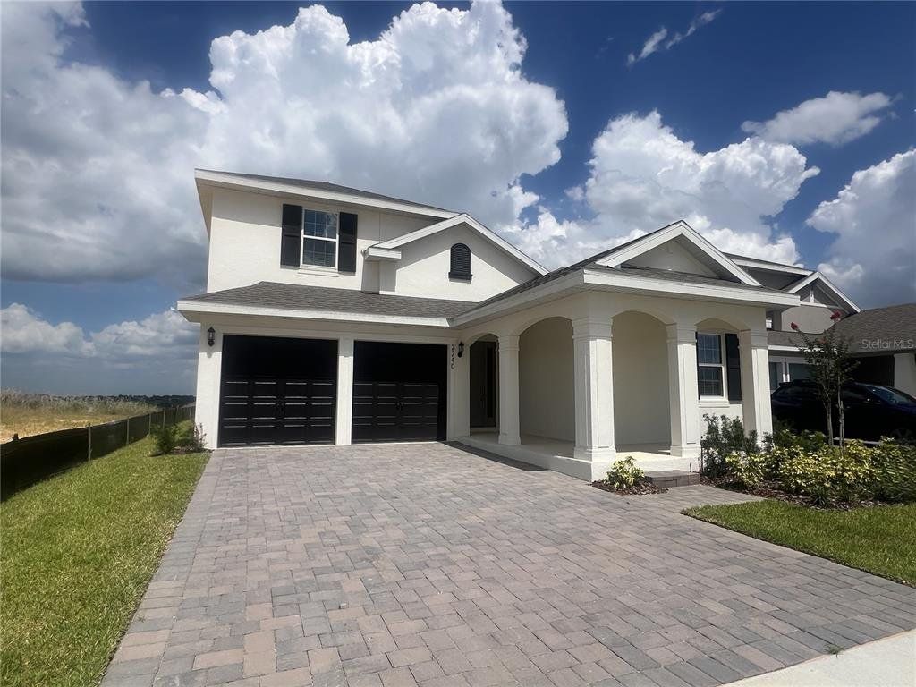 Front exterior of a new home in Hills of Minneola, Minneola, FL, highlighting curb appeal (Image 1). Front exterior of a new home in Hills of Minneola, Minneola, FL, highlighting curb appeal (Image 1).