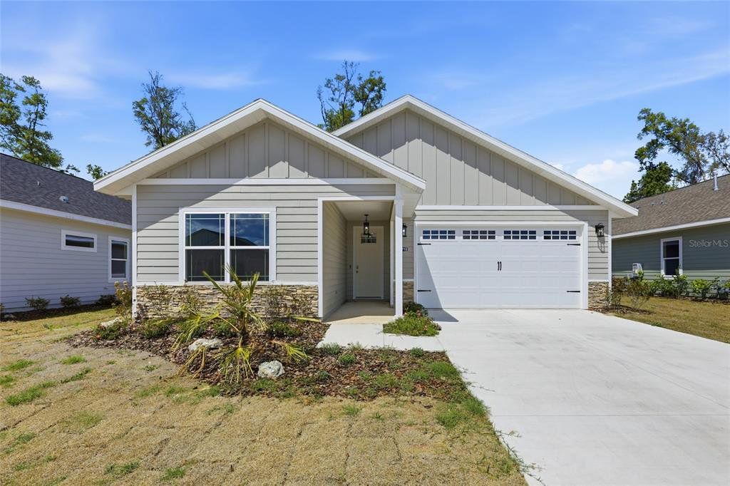 Front exterior of a new home in Grand Oaks, Gainesville, FL, highlighting curb appeal (Image 1). Front exterior of a new home in Grand Oaks, Gainesville, FL, highlighting curb appeal (Image 1).