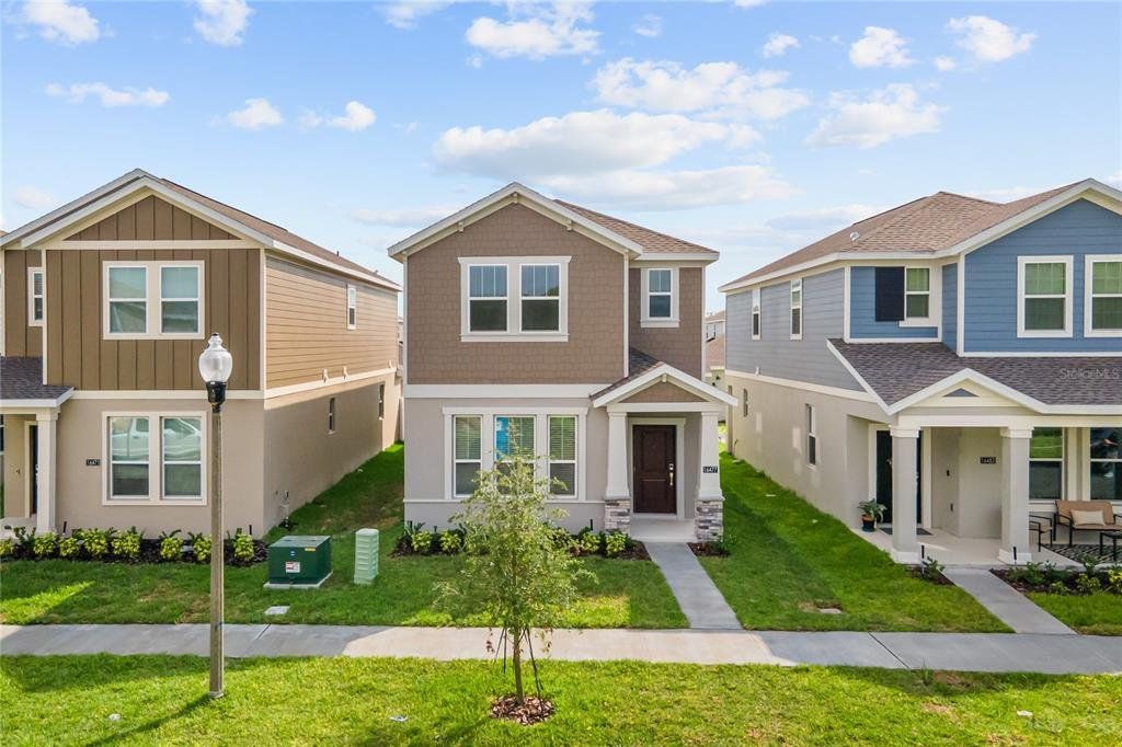 Front exterior of a new home in , Winter Garden, FL, highlighting curb appeal (Image 1).