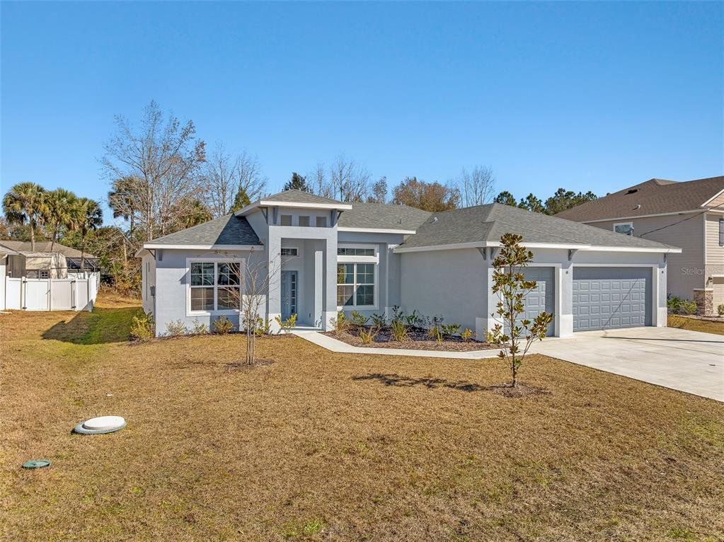 Front exterior of a new home in , Palm Coast, FL, highlighting curb appeal (Image 1). Front exterior of a new home in , Palm Coast, FL, highlighting curb appeal (Image 1).