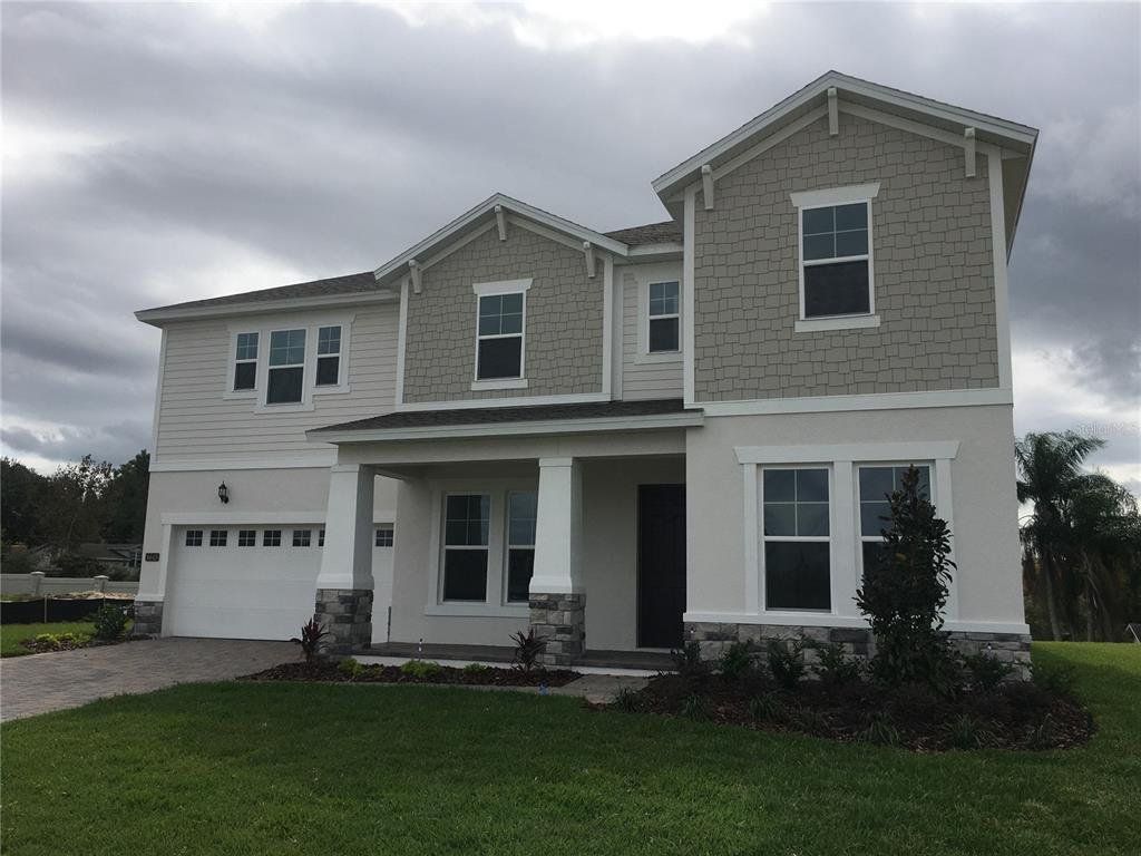 Front exterior of a new home in Palms at Windermere, Windermere, FL, highlighting curb appeal (Image 1).