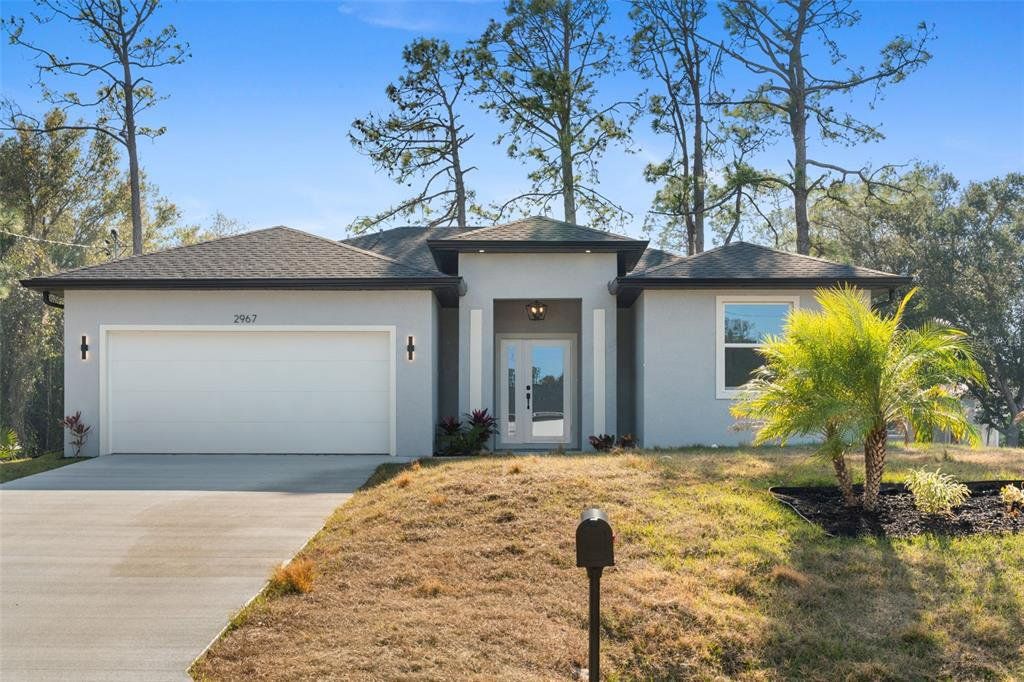 Front exterior of a new home in , North Port, FL, highlighting curb appeal (Image 1). Front exterior of a new home in , North Port, FL, highlighting curb appeal (Image 1).