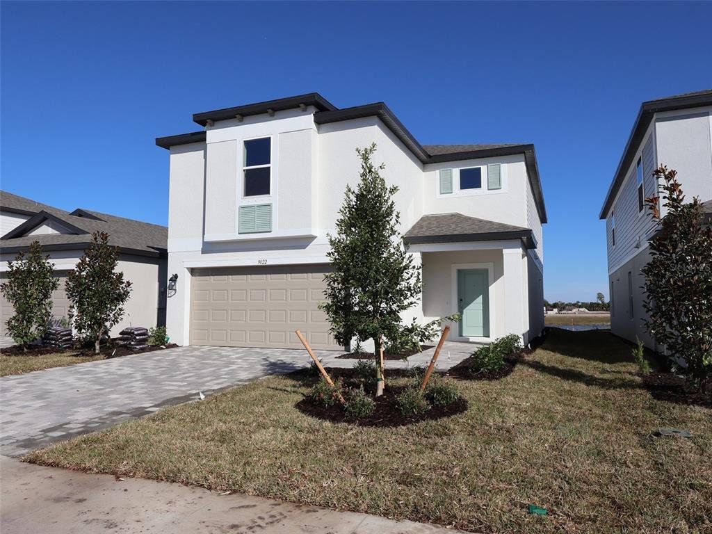 Front exterior of a new home in Southpointe, Palmetto, FL, highlighting curb appeal (Image 1). Front exterior of a new home in Southpointe, Palmetto, FL, highlighting curb appeal (Image 1).
