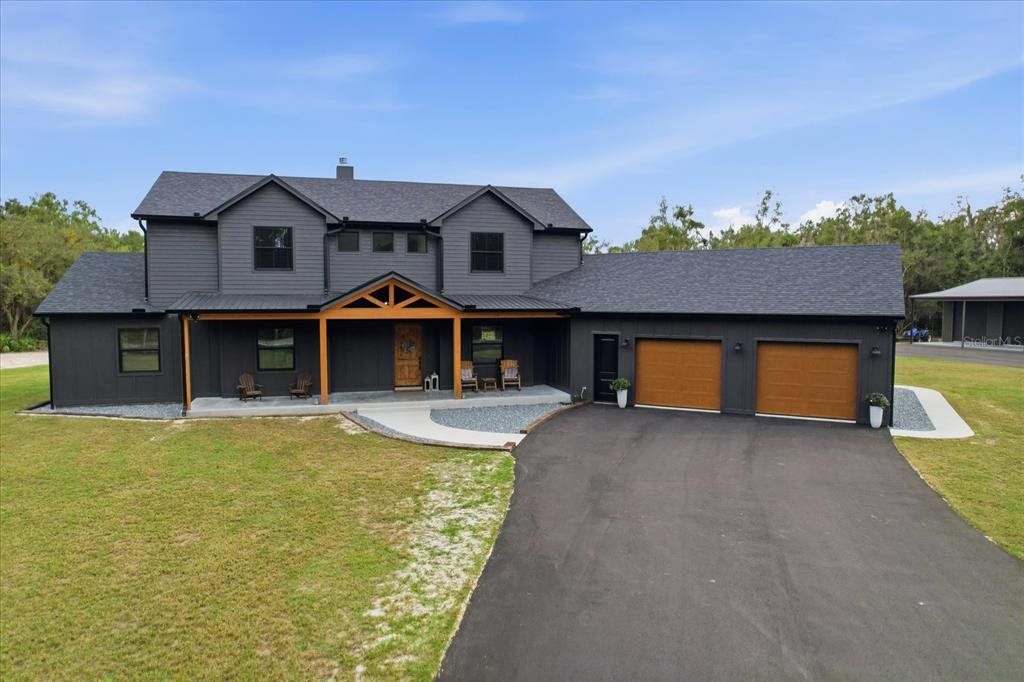 Front exterior of a new home in , Inglis, FL, highlighting curb appeal (Image 1). Front exterior of a new home in , Inglis, FL, highlighting curb appeal (Image 1).