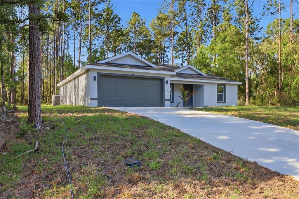 Front exterior of a new home in , Citrus Springs, FL, highlighting curb appeal (Image 1). Front exterior of a new home in , Citrus Springs, FL, highlighting curb appeal (Image 1).