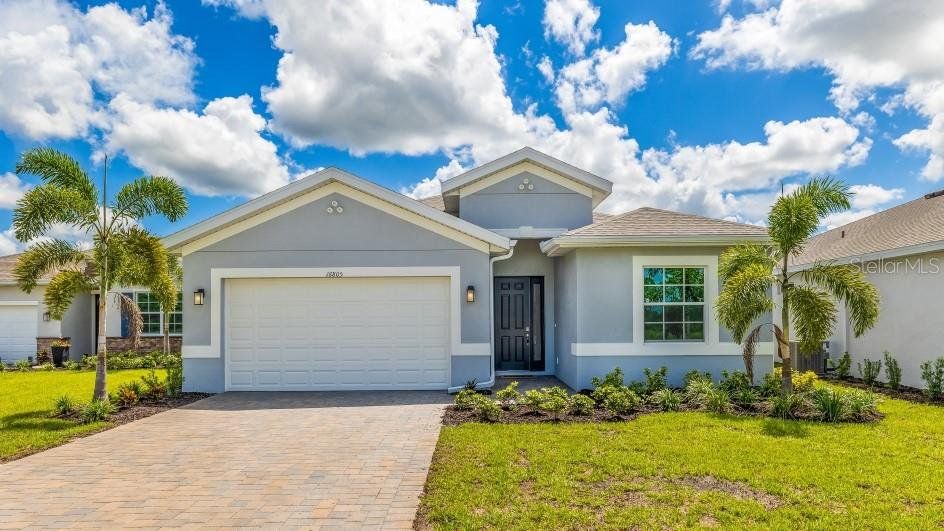 Front exterior of a new home in Coral Lakes - Tradition & Express, Punta Gorda, FL, highlighting curb appeal (Image 1). Front exterior of a new home in Coral Lakes - Tradition & Express, Punta Gorda, FL, highlighting curb appeal (Image 1).