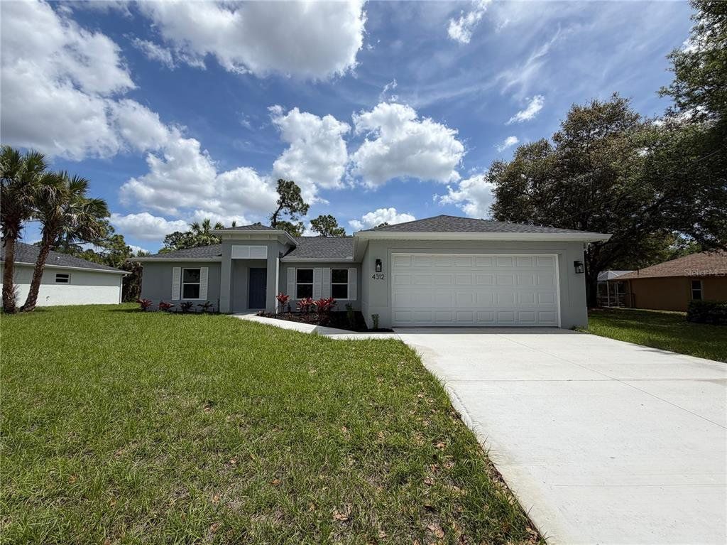 Front exterior of a new home in , North Port, FL, highlighting curb appeal (Image 1). Front exterior of a new home in , North Port, FL, highlighting curb appeal (Image 1).