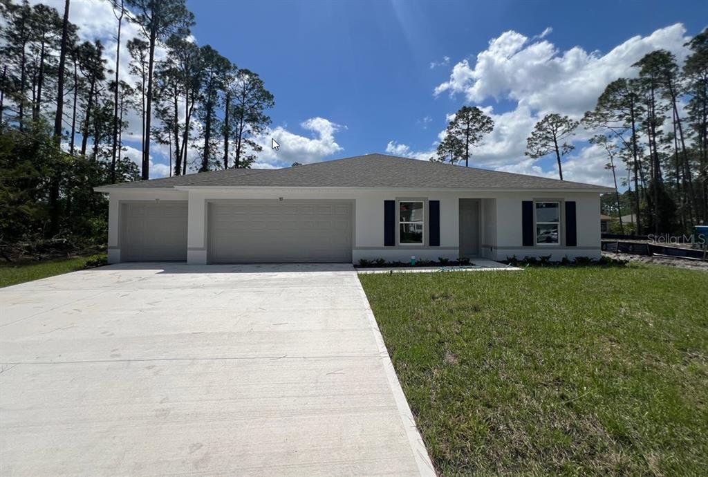 Front exterior of a new home in Palm Coast, Palm Coast, FL, highlighting curb appeal (Image 1). Front exterior of a new home in Palm Coast, Palm Coast, FL, highlighting curb appeal (Image 1).