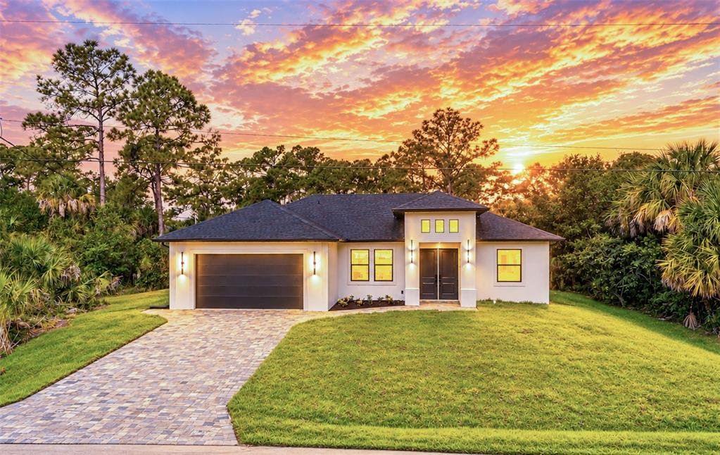 Front exterior of a new home in , North Port, FL, highlighting curb appeal (Image 1). Front exterior of a new home in , North Port, FL, highlighting curb appeal (Image 1).
