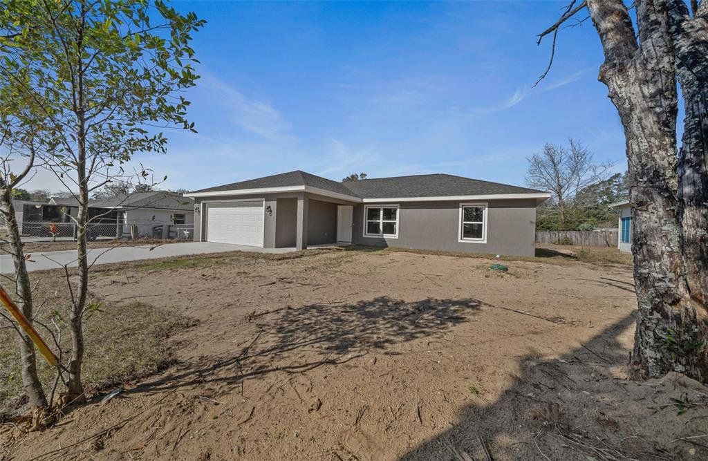 Front exterior of a new home in , Summerfield, FL, highlighting curb appeal (Image 1). Front exterior of a new home in , Summerfield, FL, highlighting curb appeal (Image 1).