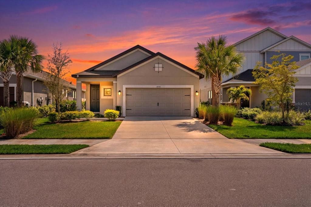 Front exterior of a new home in Park East at Azario, Bradenton, FL, highlighting curb appeal (Image 1). Front exterior of a new home in Park East at Azario, Bradenton, FL, highlighting curb appeal (Image 1).