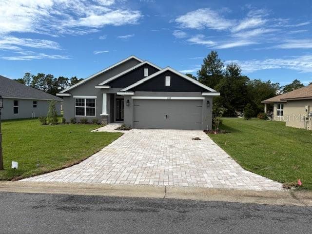 Front exterior of a new home in Juliette Falls, Dunnellon, FL, highlighting curb appeal (Image 1). Front exterior of a new home in Juliette Falls, Dunnellon, FL, highlighting curb appeal (Image 1).