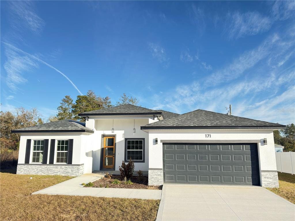 Front exterior of a new home in , Ocala, FL, highlighting curb appeal (Image 1). Front exterior of a new home in , Ocala, FL, highlighting curb appeal (Image 1).