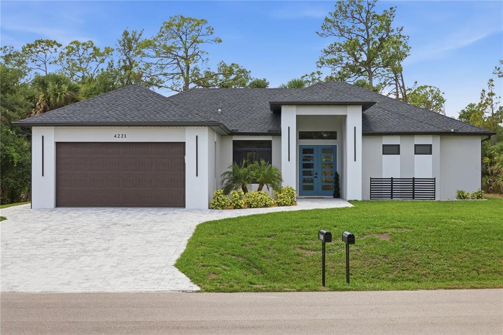 Front exterior of a new home in , North Port, FL, highlighting curb appeal (Image 1). Front exterior of a new home in , North Port, FL, highlighting curb appeal (Image 1).