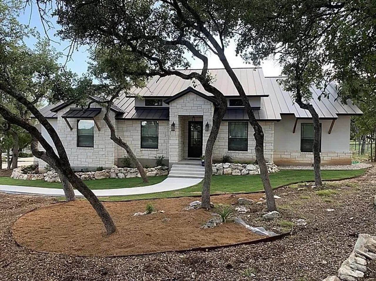 Front exterior of a home in the Ensenada Shores community, located in Canyon Lake, TX (Image 2).