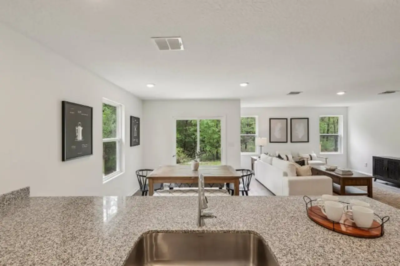 A living room with a large table and chairs. A living room with a large table and chairs.