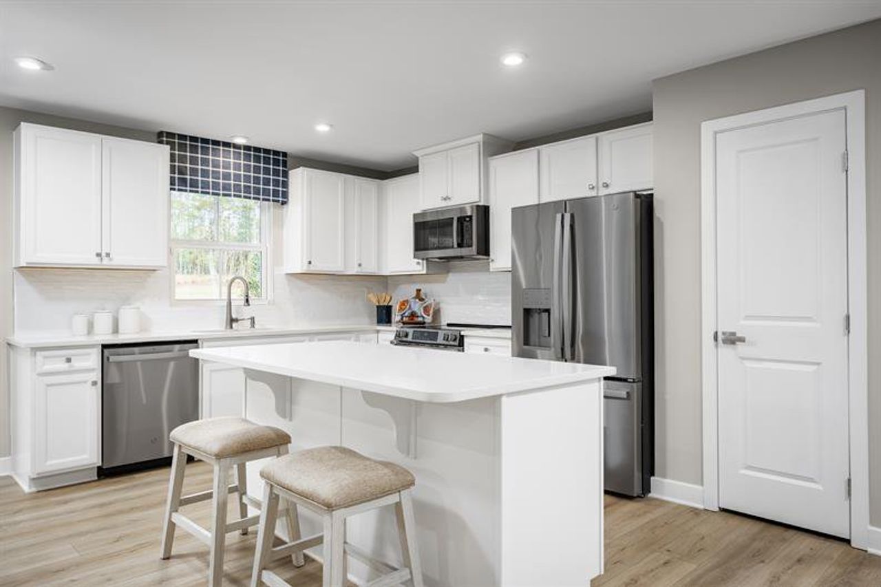 Welcome to Overture Pointe with single-family and ranch homes in a sidewalk-lined neighborhood.