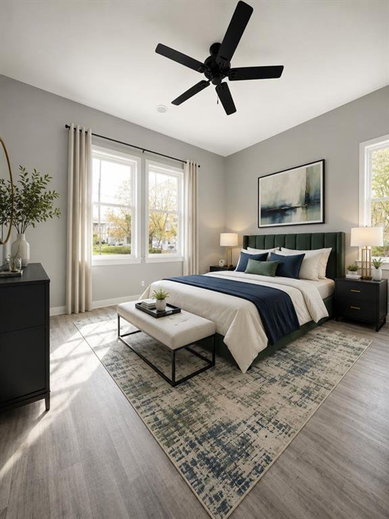 Expansive room featuring light wood-finish flooring, a contemporary ceiling fan, and two large windows